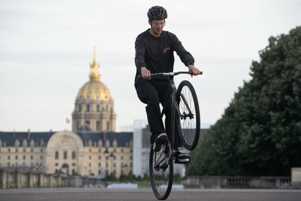 Jackson en équilibre sur la roue arrière devant les Invalides.