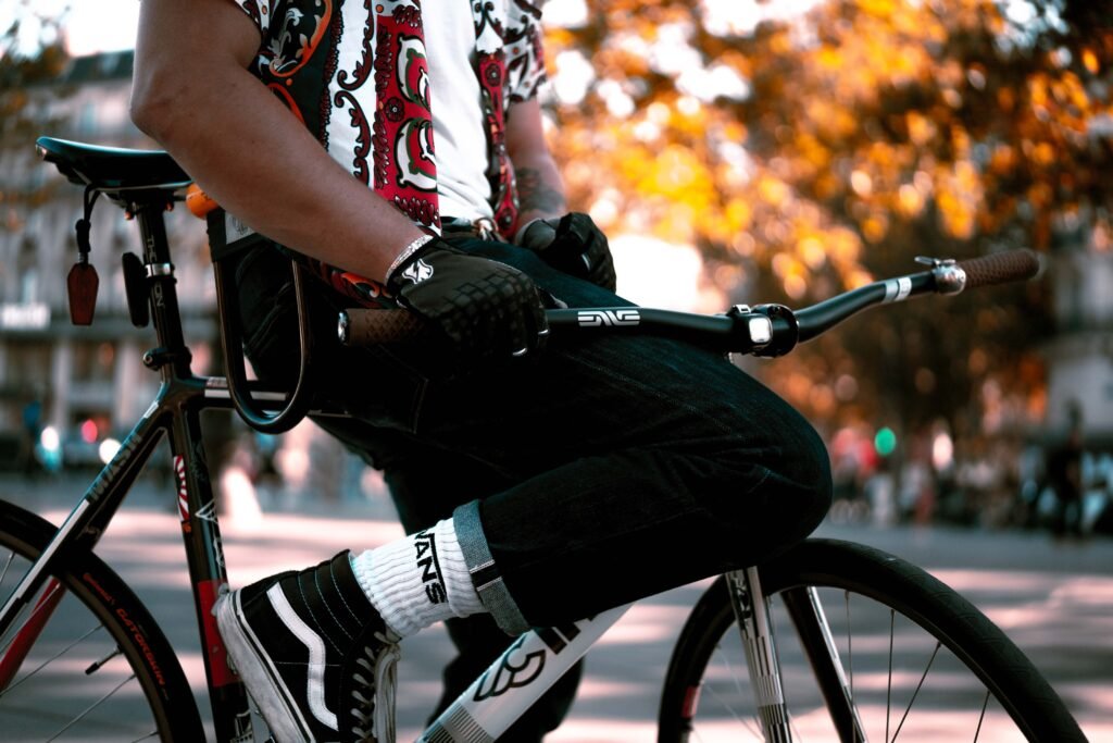 Gros plan sur les mains gantées du rider, le cadre et les straps de pédales.